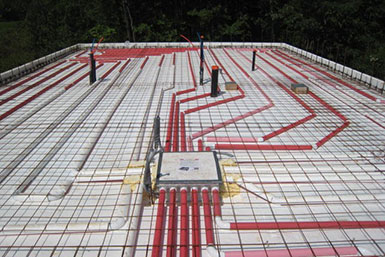 The heated floor system is a network of pipes from a furnace box that is cast in the slab